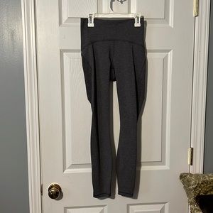 Gray Lululemon leggings with mesh on bottom side of legs, size 4